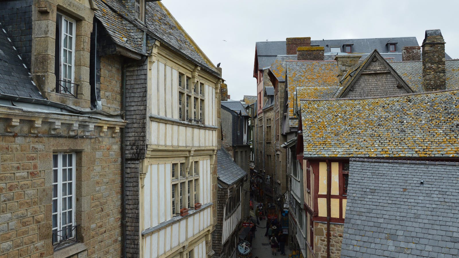 Narrow medieval street in the village of Mont Saint-Michel with historic architecture