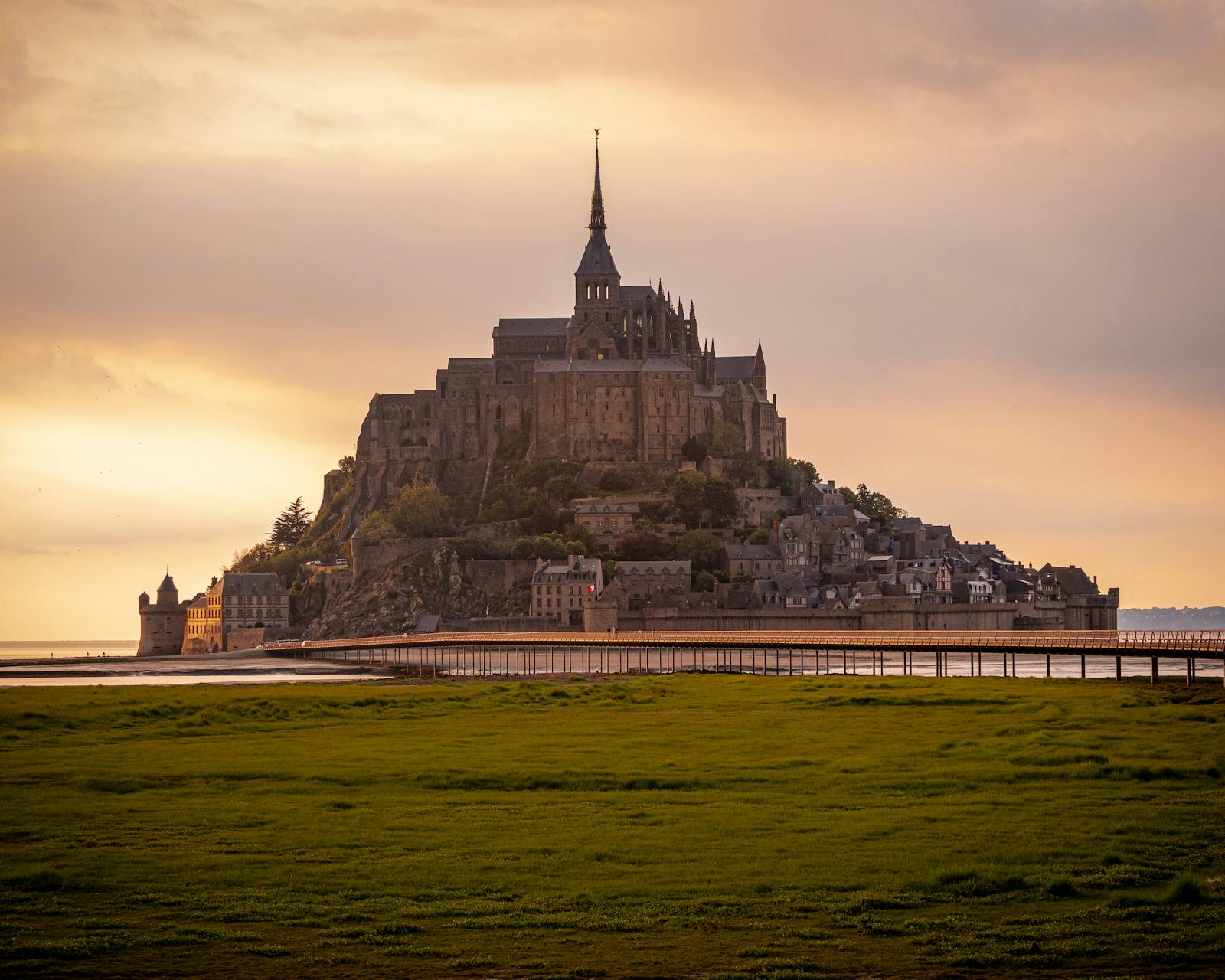 Mont Saint-Michel with sunset light illuminating historic architecture
