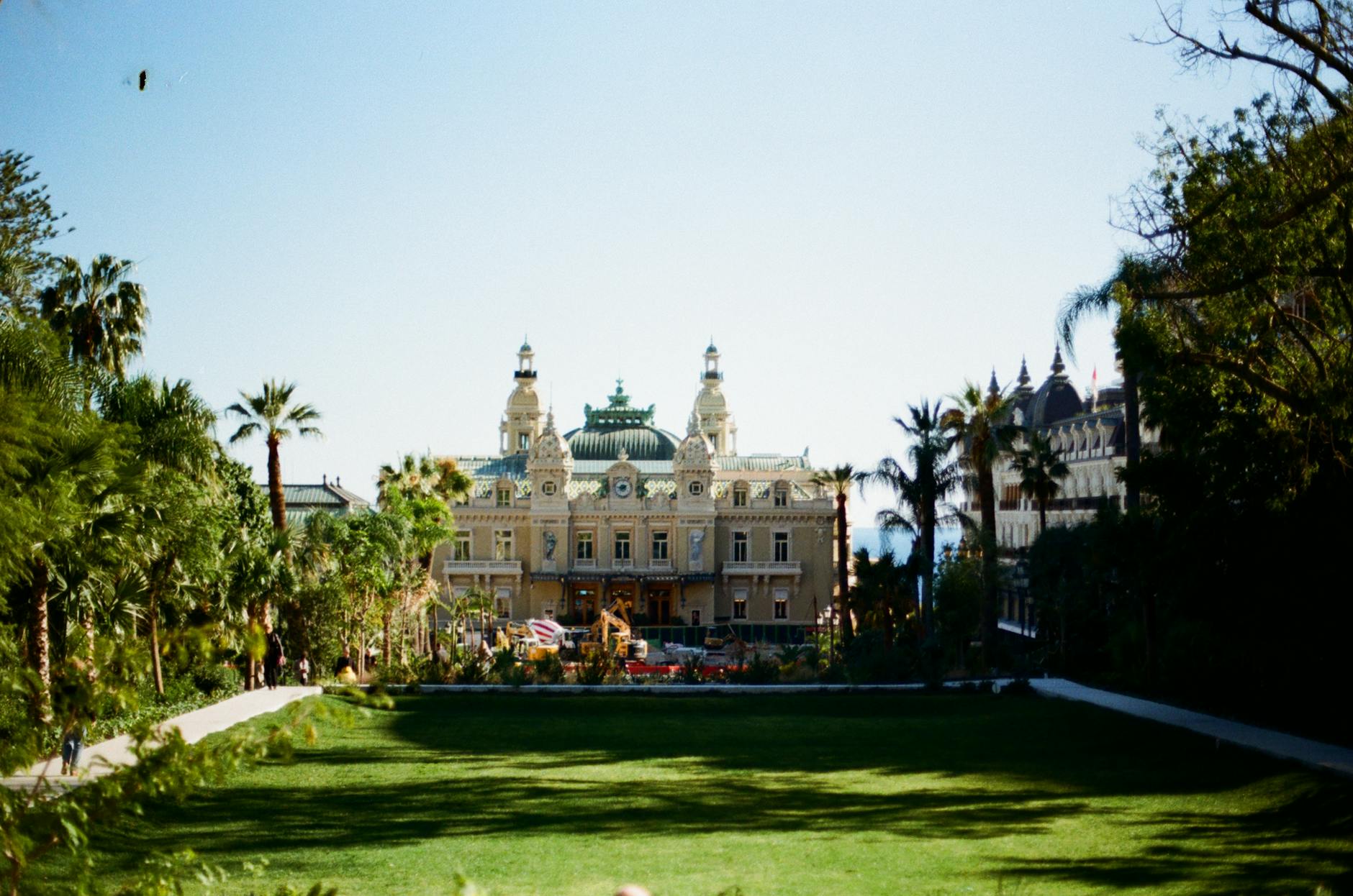 Monte Carlo Casino in Monaco surrounded by lush greenery and landscaped gardens