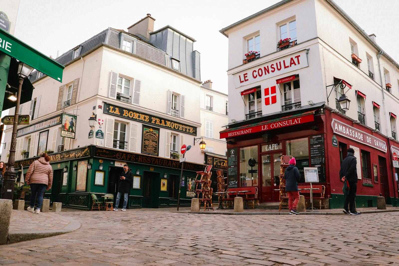 Iconic Montmartre cafes lining a classic Paris street