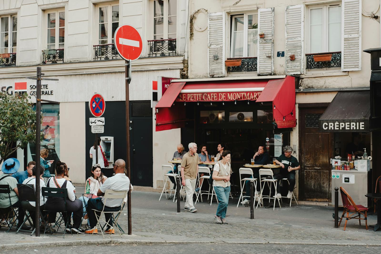 Small Montmartre cafe with outdoor dining tables on a Paris side street