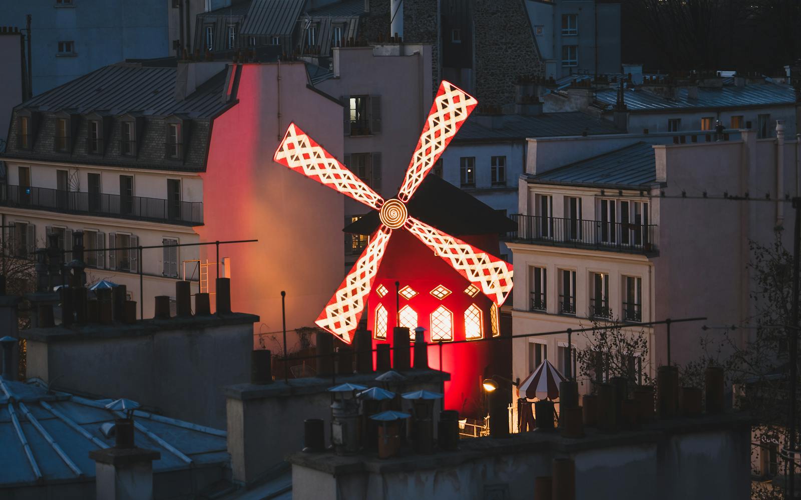 Evening view of the Moulin Rouge red windmill landmark in Paris