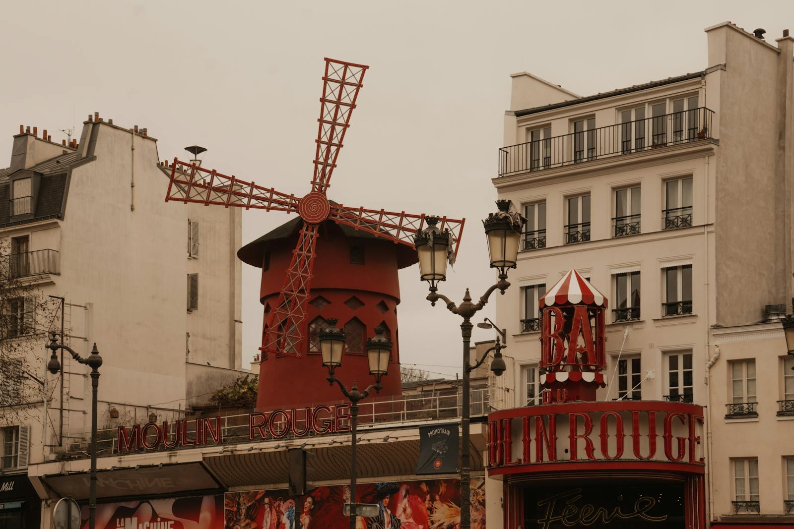 The historic Moulin Rouge cabaret in Montmartre Paris featuring its red windmill landmark