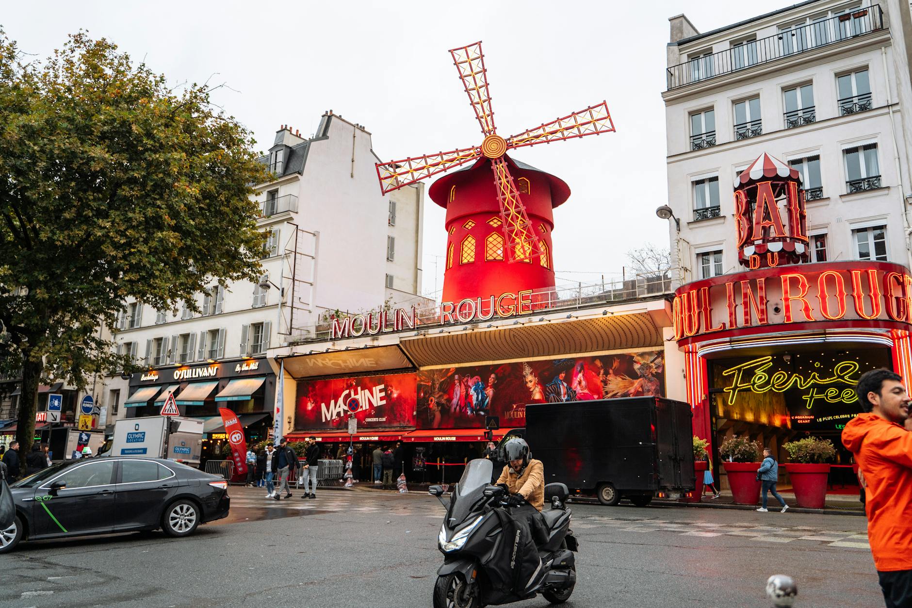 Moulin Rouge surrounded by Paris city life