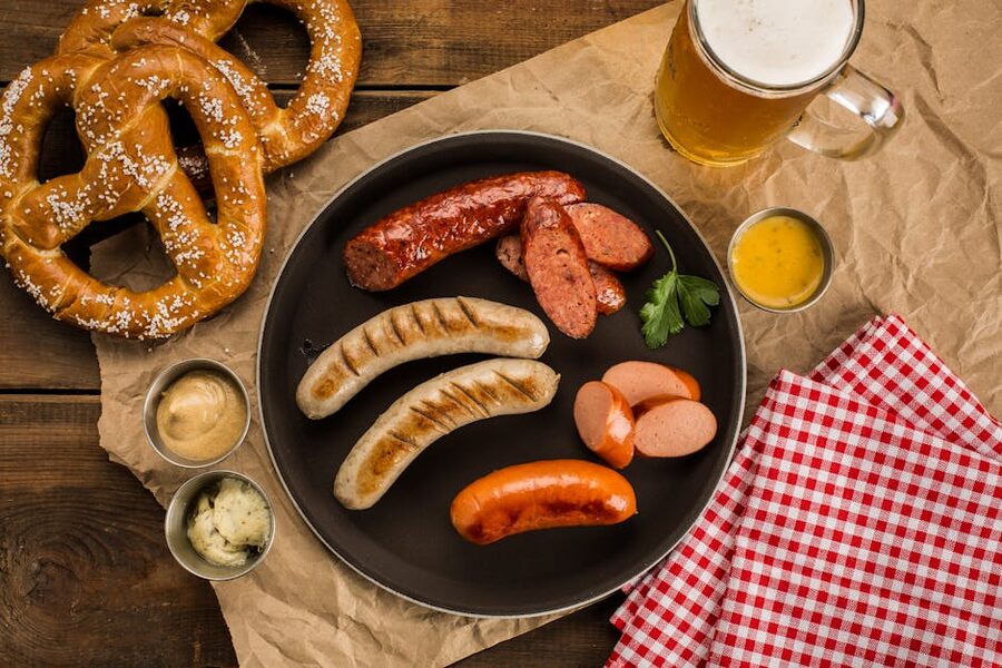 Top view German-style meal with sausages and pretzels