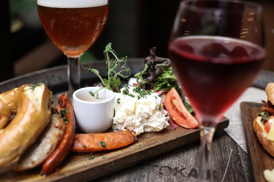 Wooden platter with sausages and salad