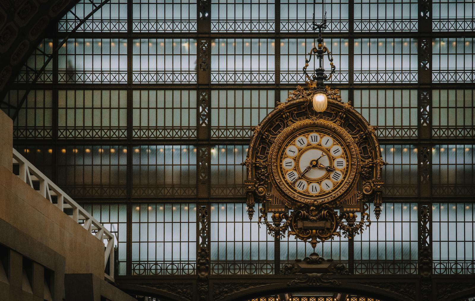 Elegant antique clock inside the Musée d'Orsay with ornate Beaux-Arts design