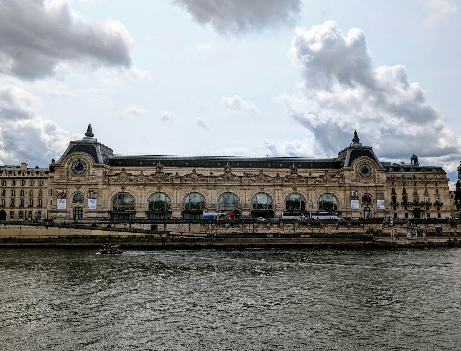 Exterior view of the Musée d'Orsay alongside the Seine River in Paris