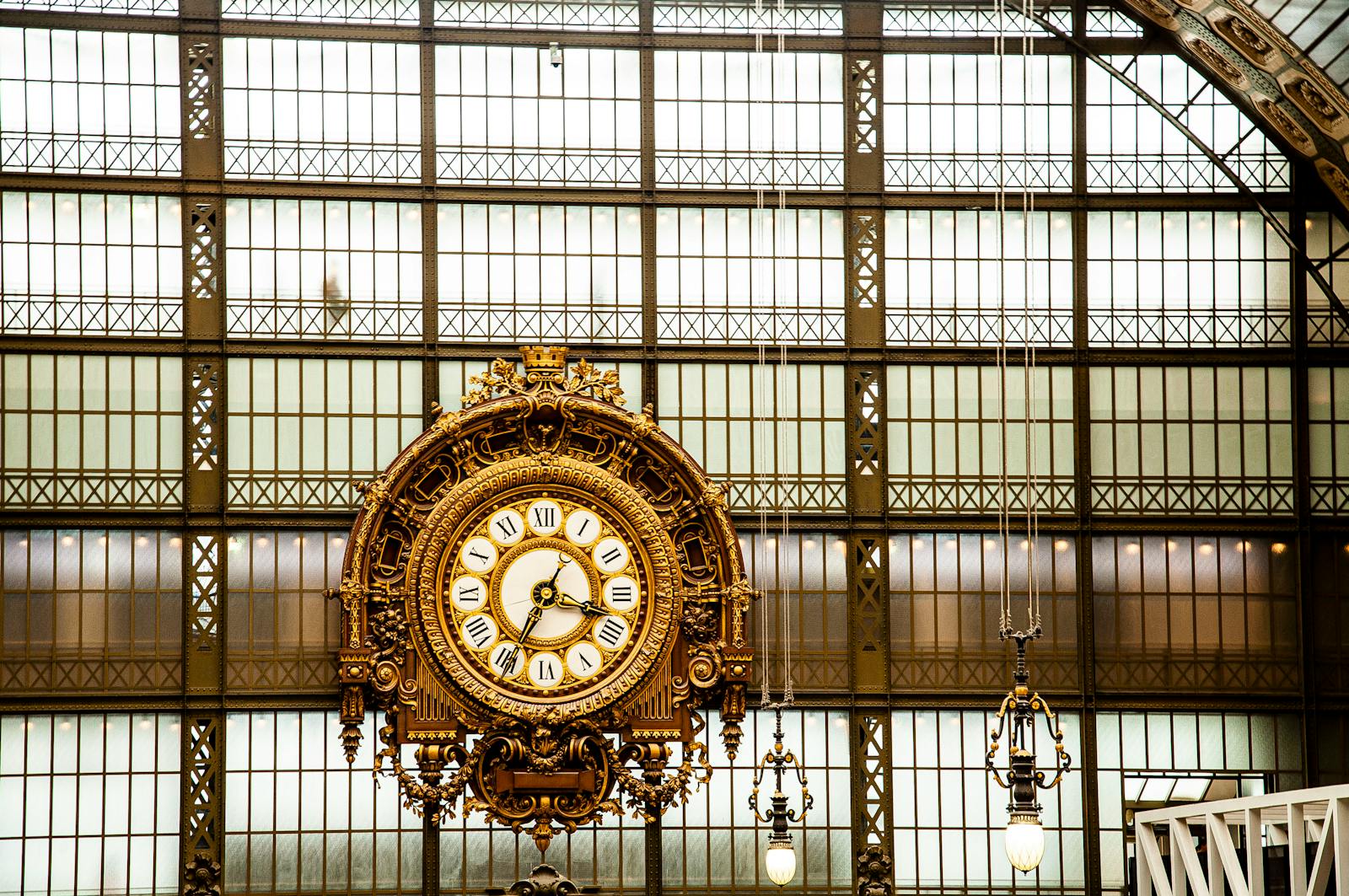 Elegant gilded clock inside the Musée d'Orsay showcasing classic Beaux-Arts architecture