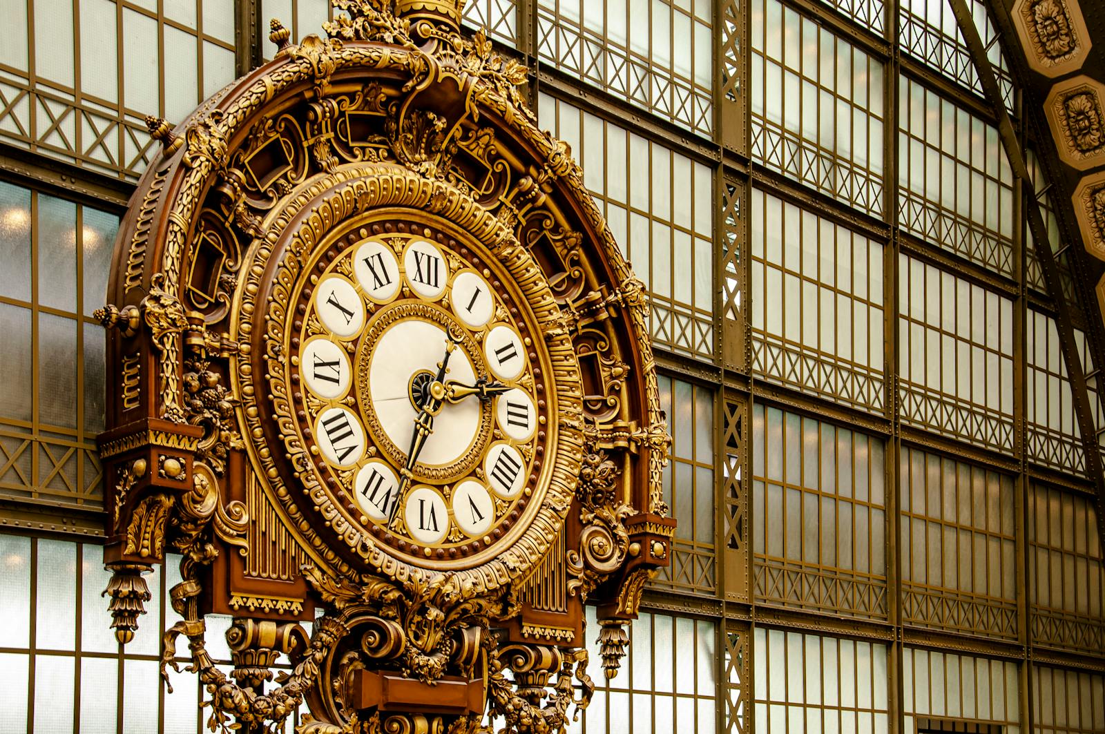 Intricate golden clock inside the historic Musée d'Orsay in Paris France
