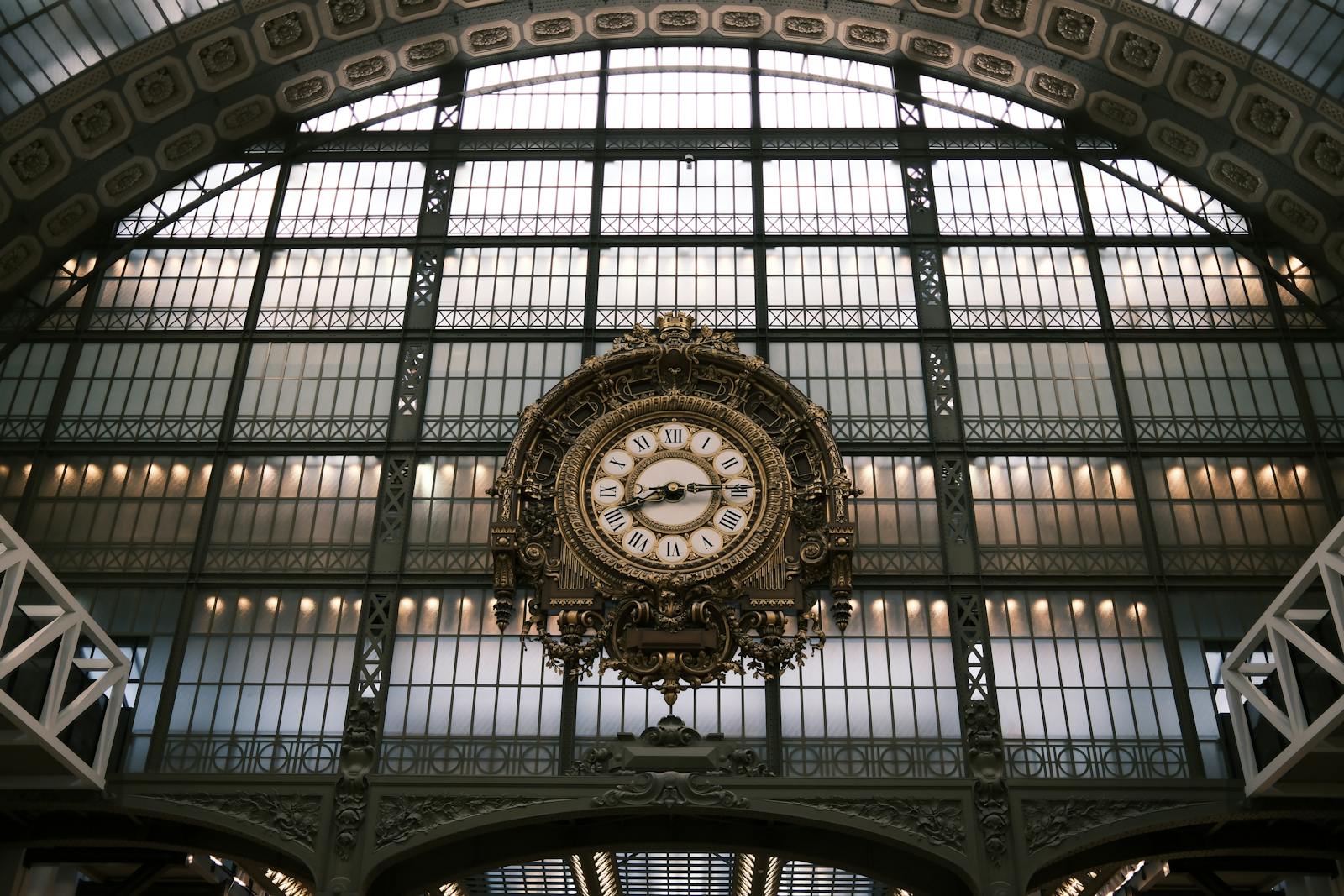 Grand ornate clock inside the Musée d'Orsay showing intricate Beaux-Arts design