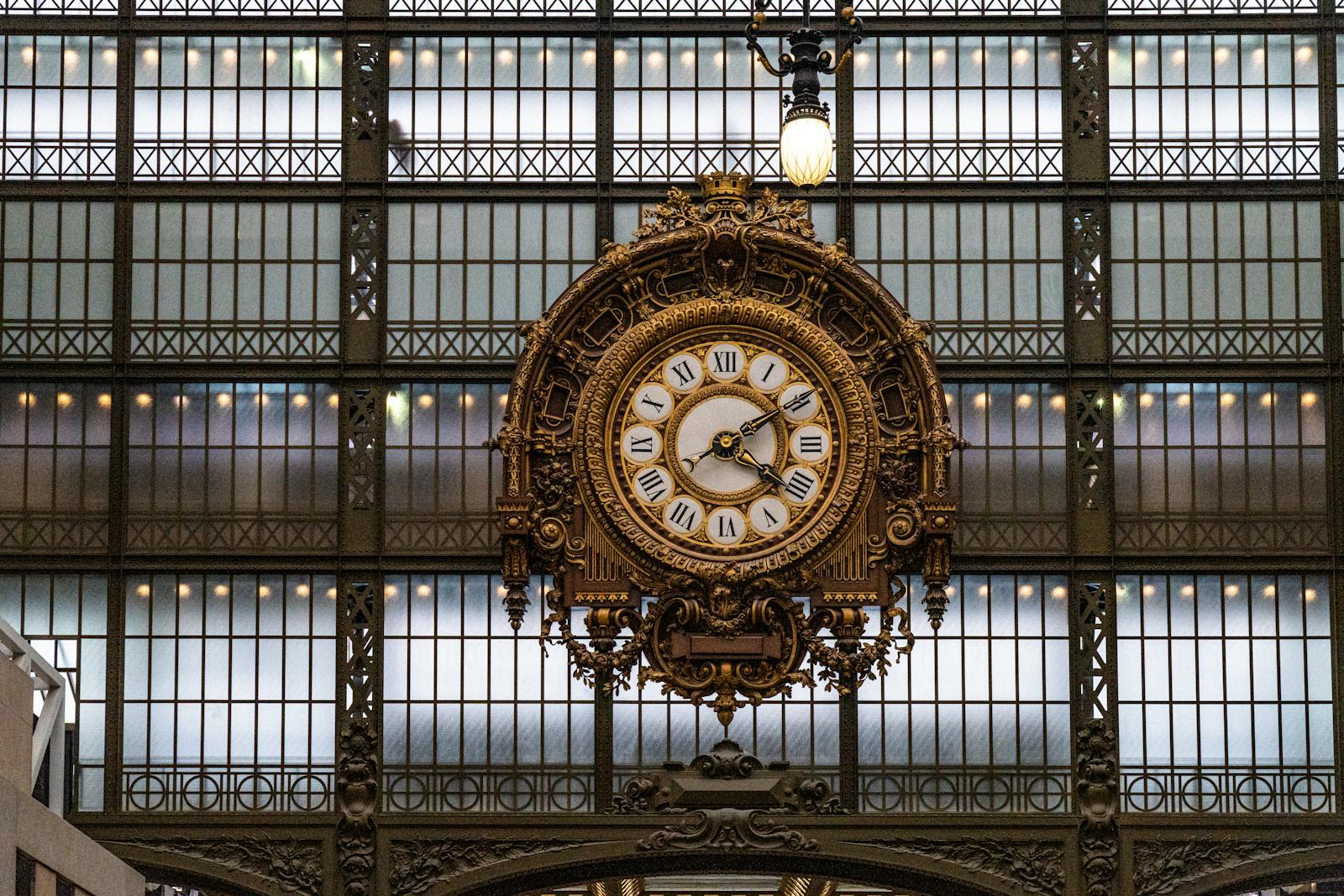Close-up of the ornate clock inside the Musée d'Orsay capturing architectural detail