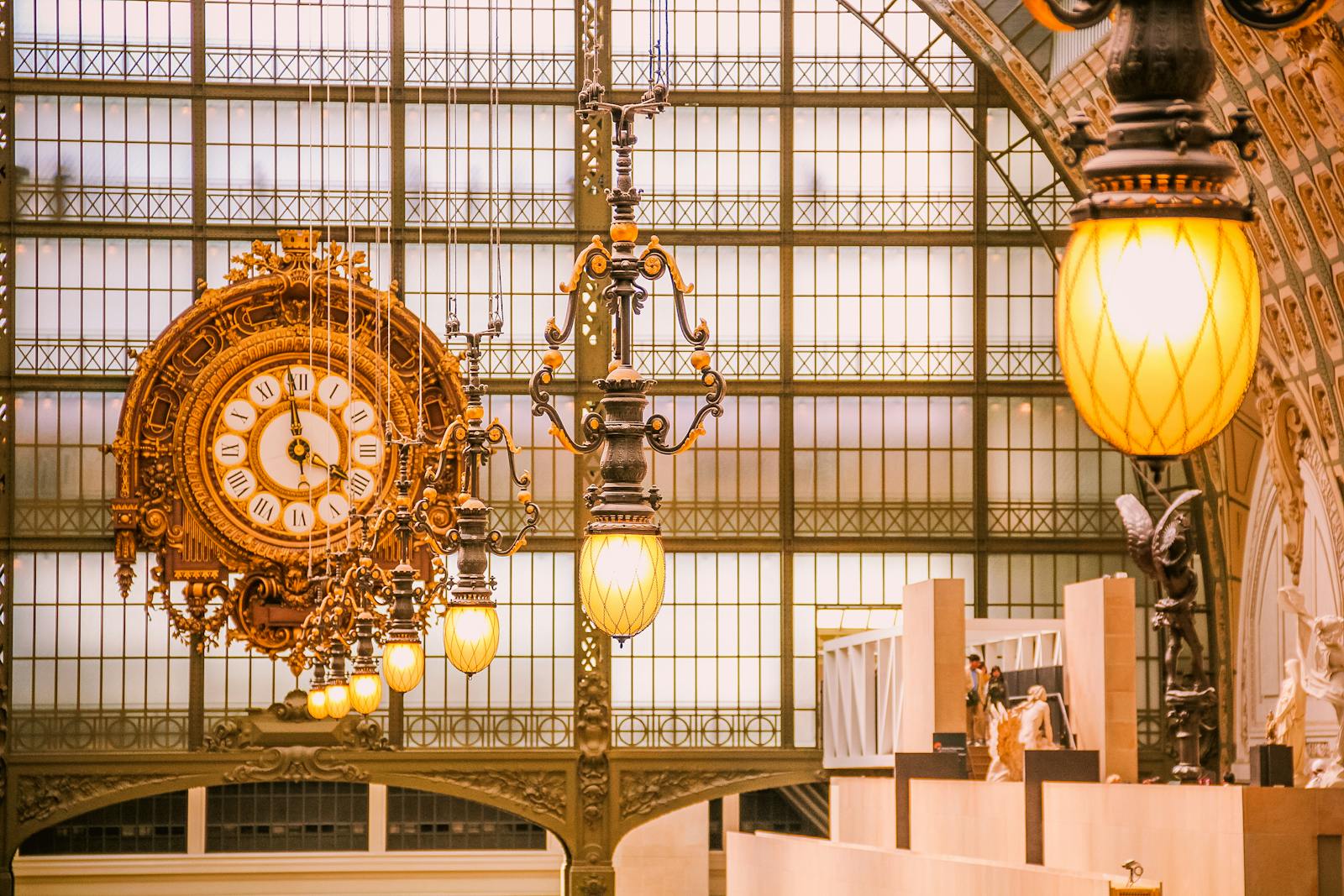 Close-up of the ornate clock and interior architecture of the Musée d'Orsay with warm lighting