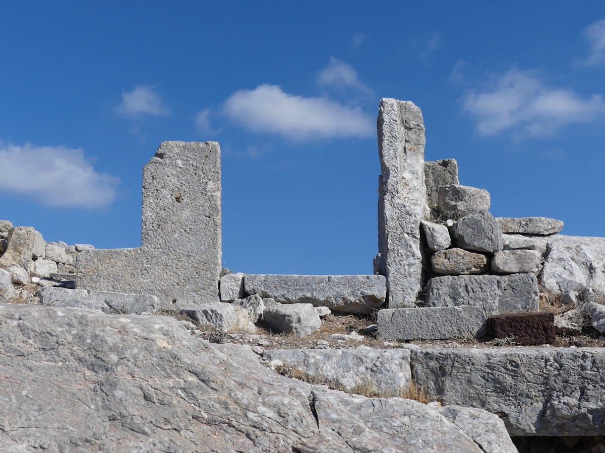 Ancient stone ruins of Mycenae against a vivid blue sky