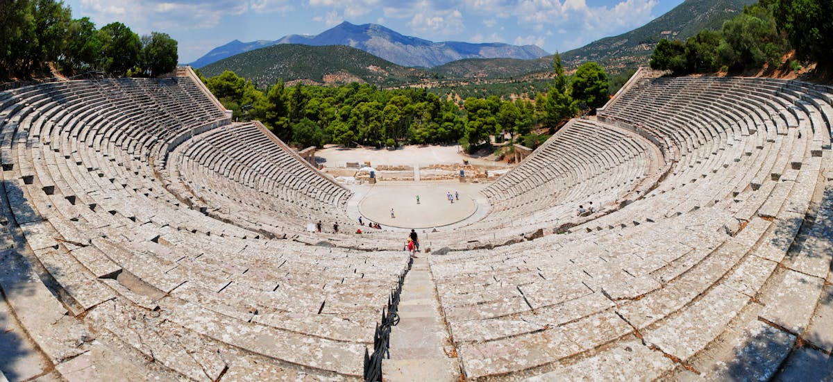 Panoramic view of the ancient theater of Epidaurus surrounded by green hills