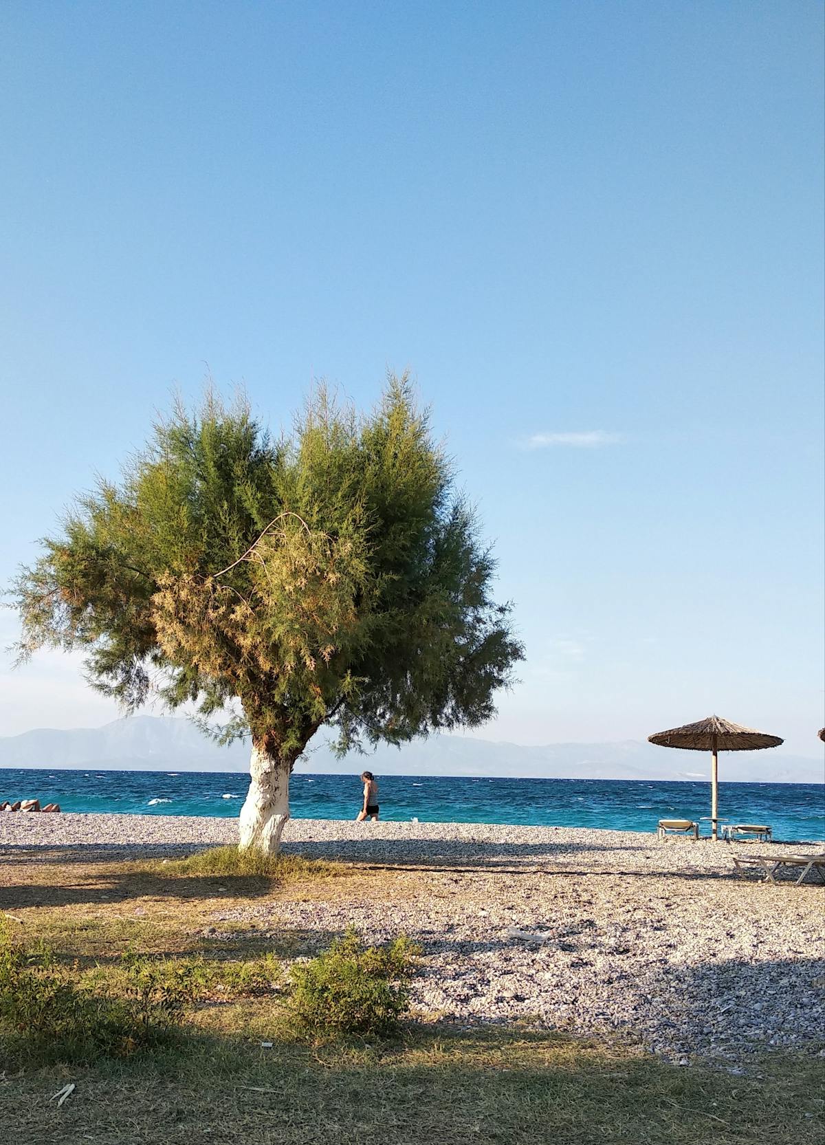 Beautiful beach in the Korinthia region near Mycenae with deep blue sky and clear waters