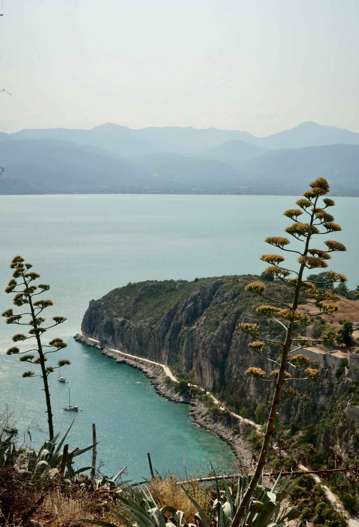 Sailboats along the coastline near Nafplio with mountains in the background