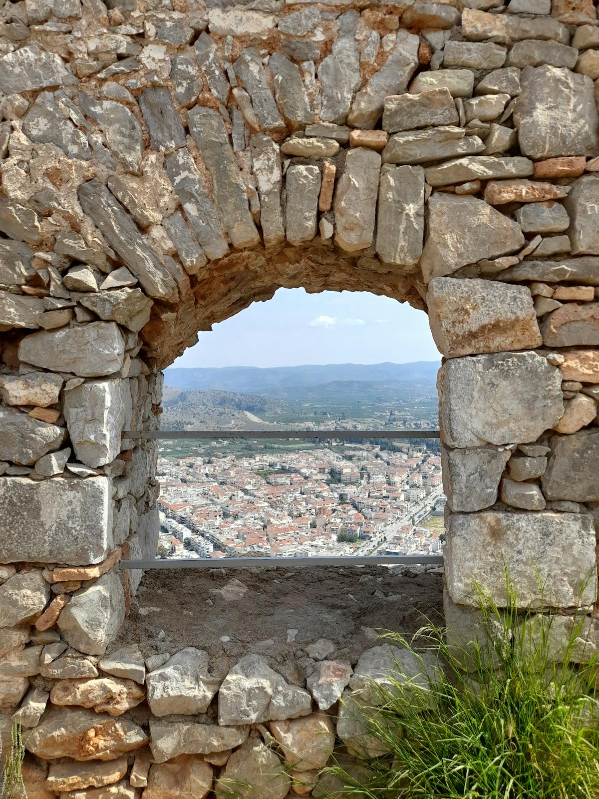 Stone archway inside the Palamidi fortress in Nafplio overlooking the town below