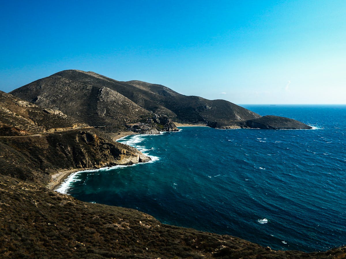 Aerial view of the dramatic Peloponnese coastline with deep blue waters and rocky shores