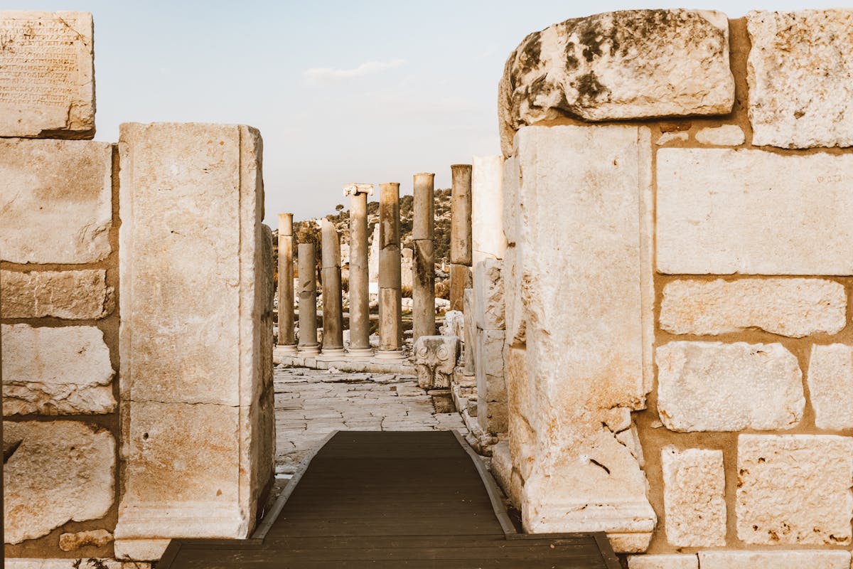 Stone columns among ancient ruins with blue sky overhead