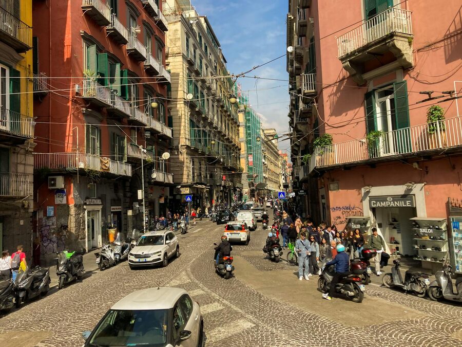 Naples city street with scooters and pedestrians