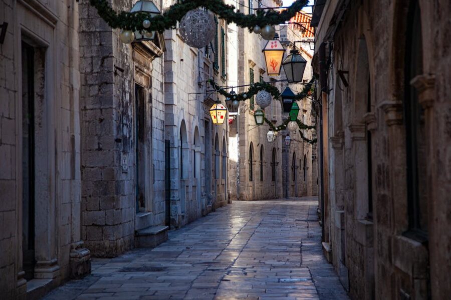 Narrow alley with ancient buildings and lanterns