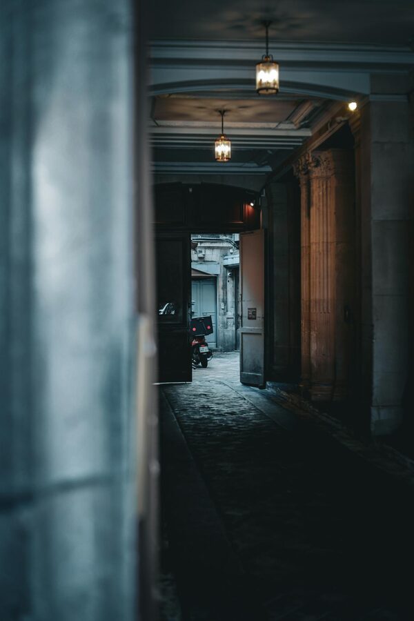 Narrow cobblestone alley in Paris at night with ambient lighting