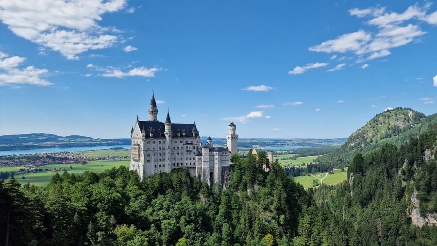 Aerial view of Neuschwanstein Castle surrounded by greenery