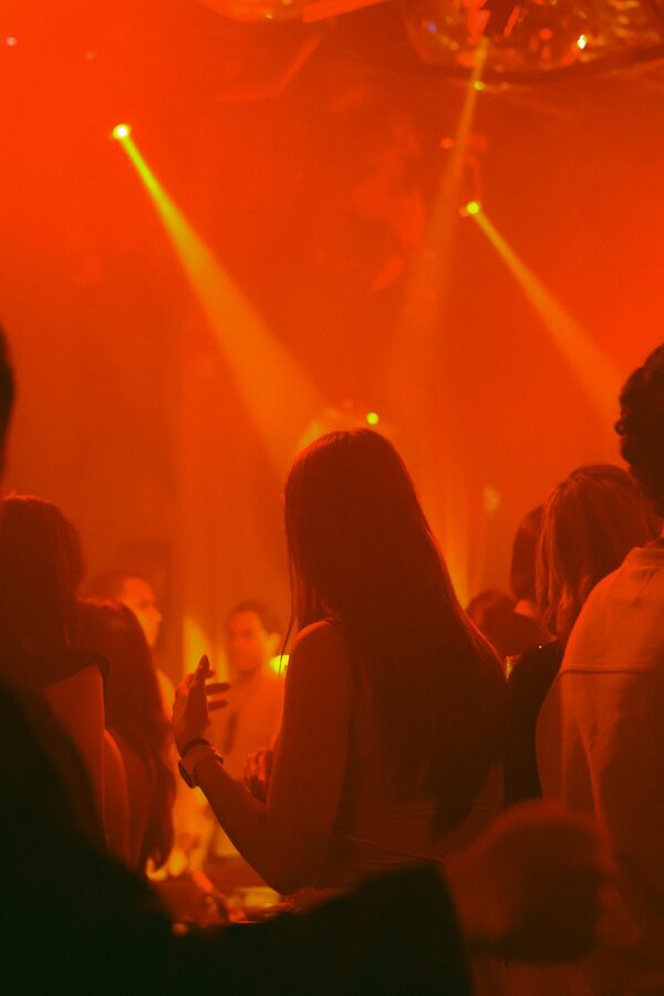 Nightclub scene with red lighting and people dancing