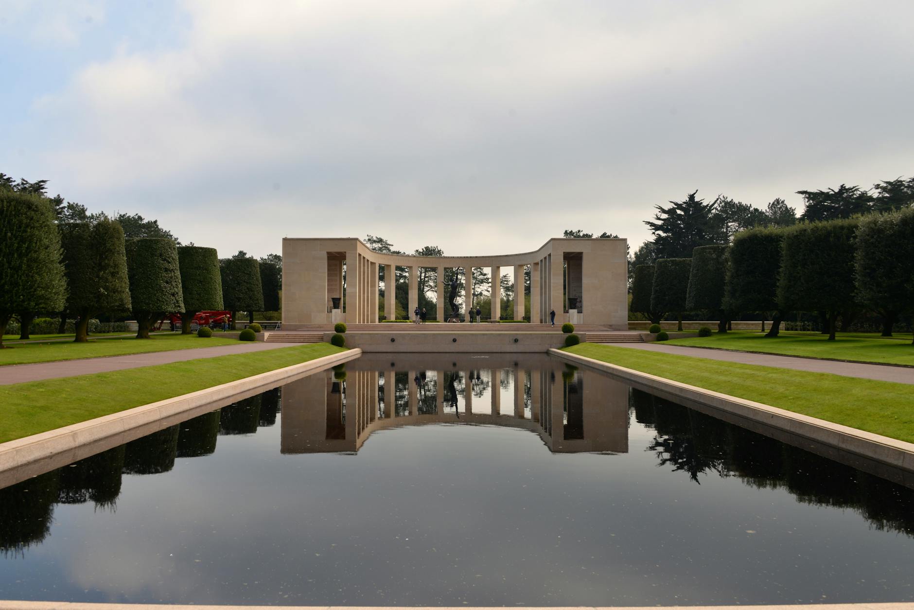 Reflective pool and bronze statue at the Normandy American Cemetery memorial