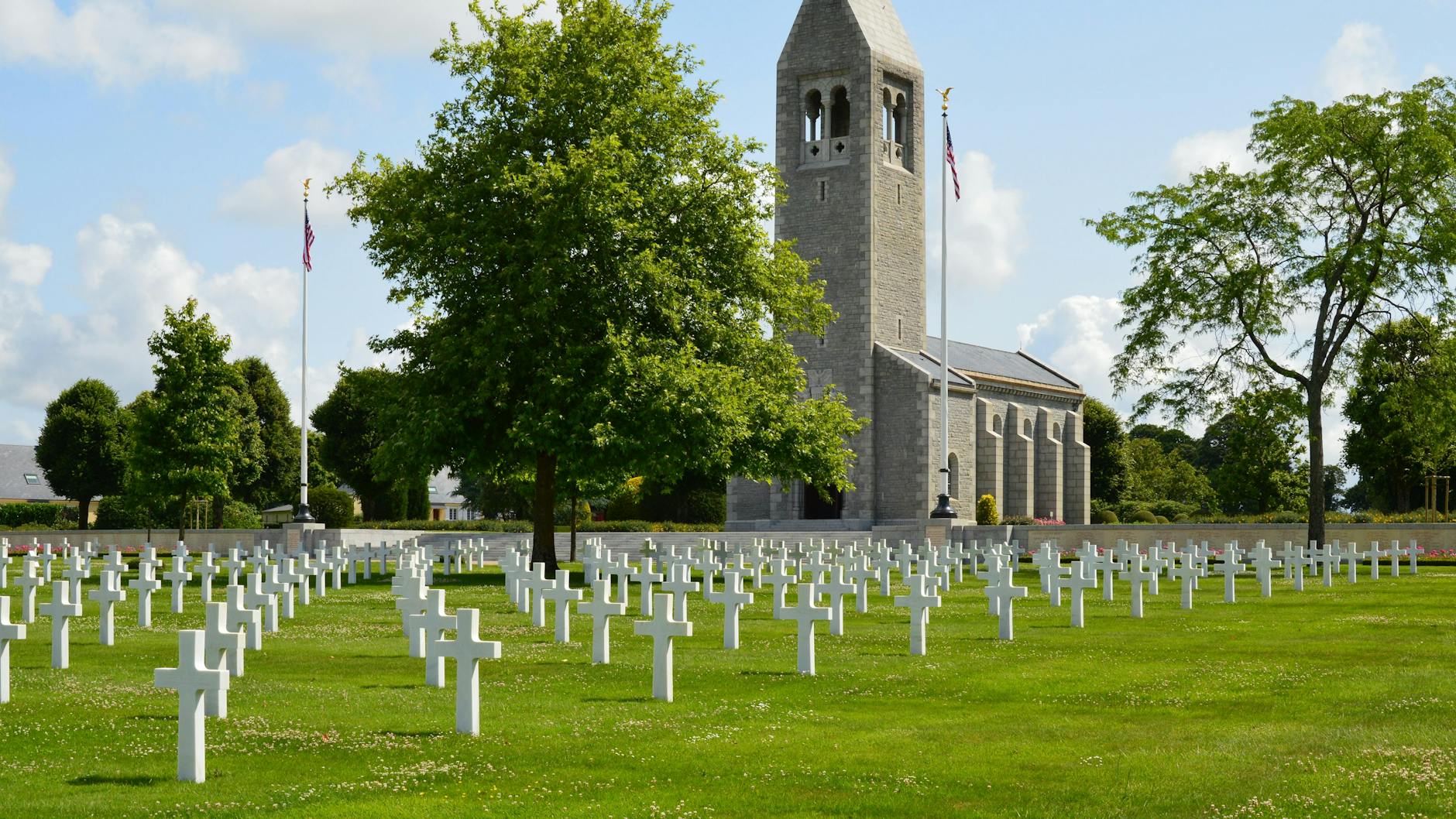 Tranquil view of white crosses at the Normandy American Cemetery under soft sky