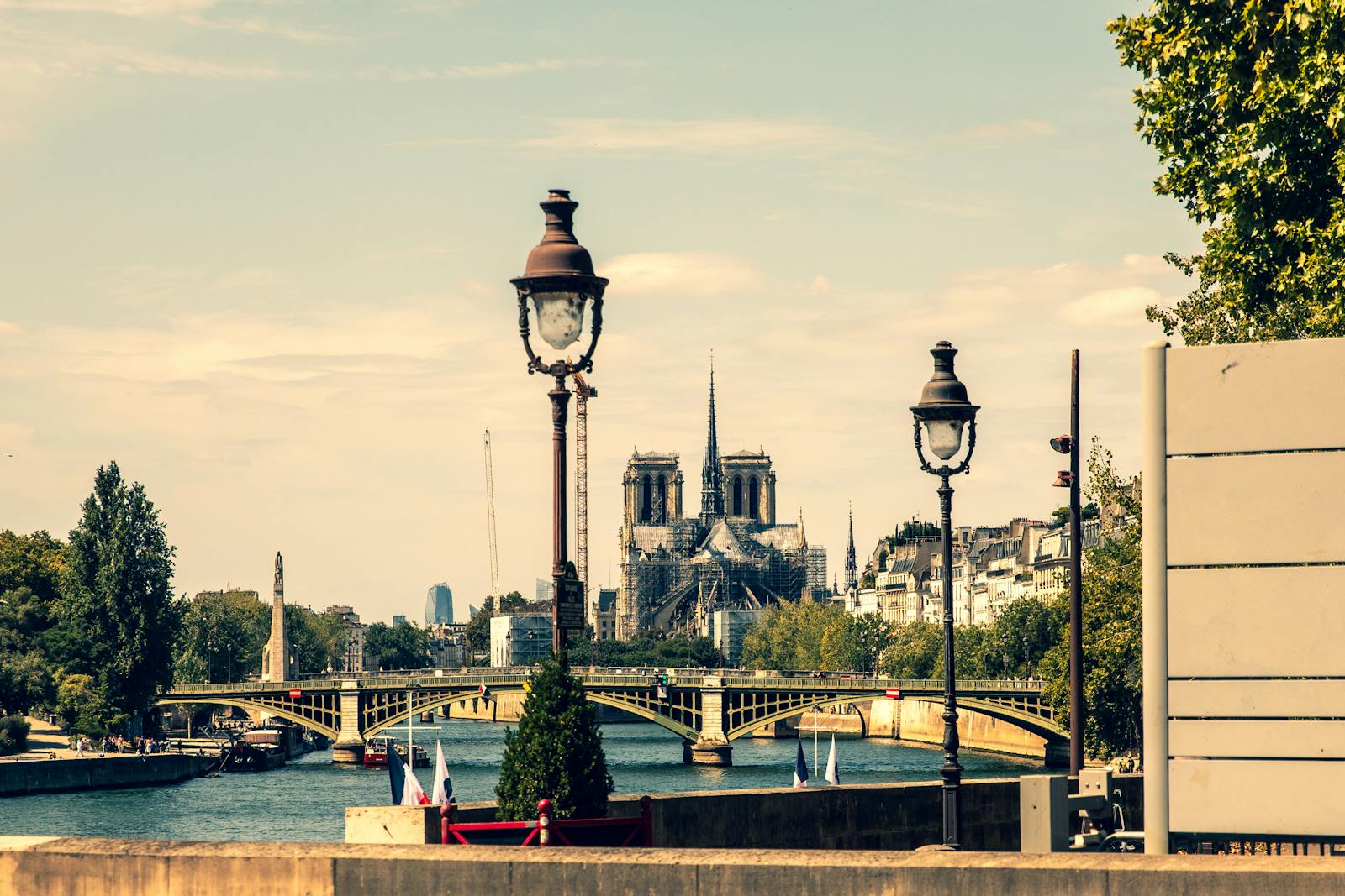 Notre-Dame Cathedral viewed from the Seine River with vintage Paris lampposts