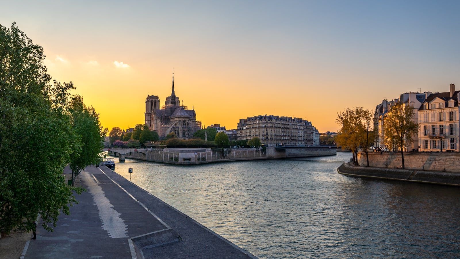 Notre-Dame in Paris at sunset over the Seine river