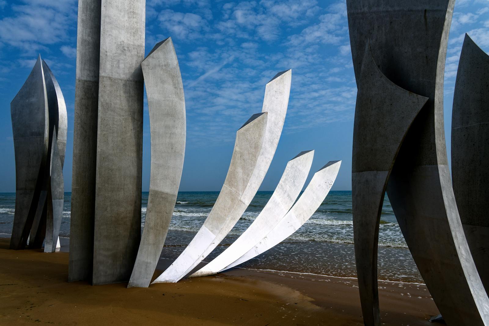 Omaha Beach Memorial sculptures at Saint-Laurent-sur-Mer with sea and sky behind