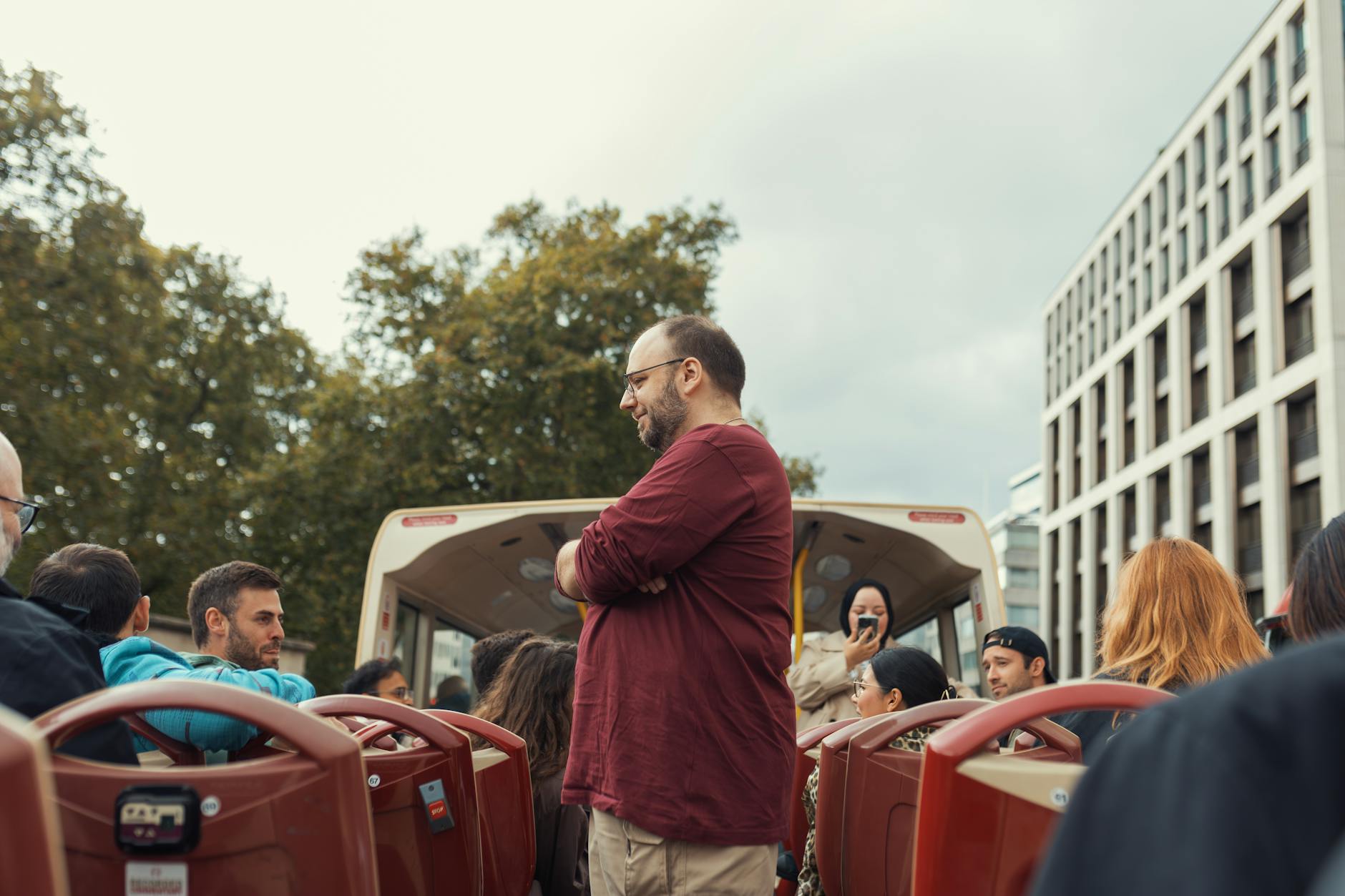 Open-top bus ride on a cloudy urban day