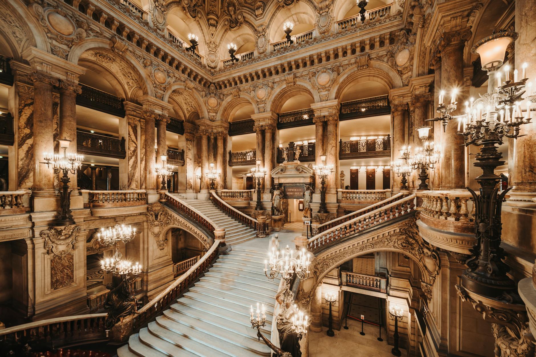 Opera Garnier grand staircase with ornate balustrades and marble interior