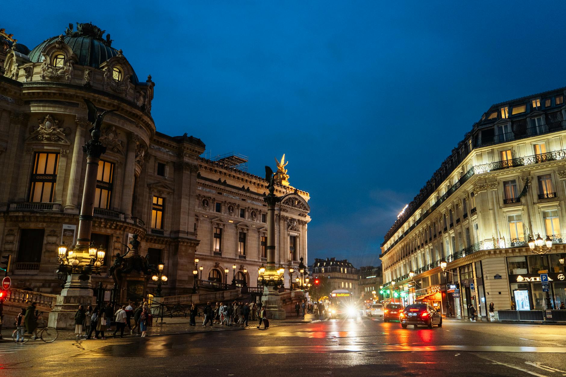 Illuminated Paris night scene with Opéra Garnier and city life