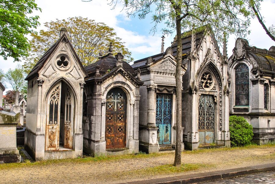 Ornate historic mausoleums with Gothic architecture in Pere Lachaise Cemetery