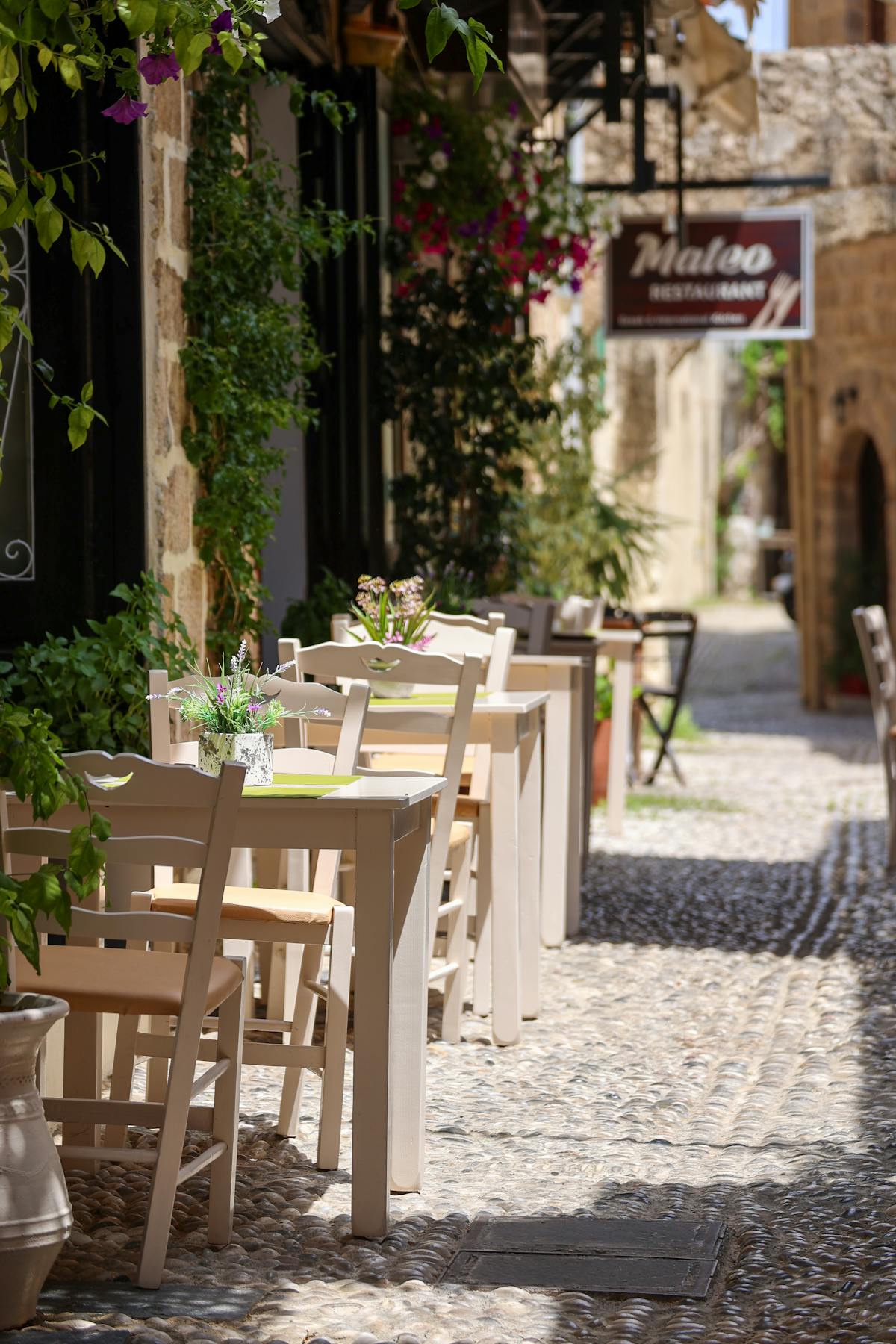 Quaint outdoor café with tables set on a cobblestone street