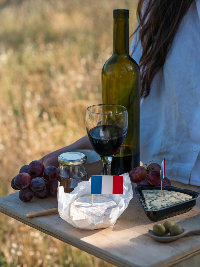 Relaxing outdoor picnic with French wine cheese and grapes