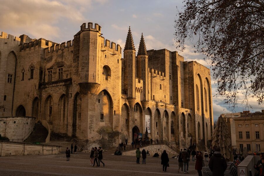 Palais des Papes illuminated at sunset in Avignon Provence