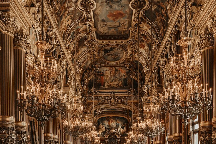 Baroque interior of Palais Garnier with chandeliers and ornate ceilings