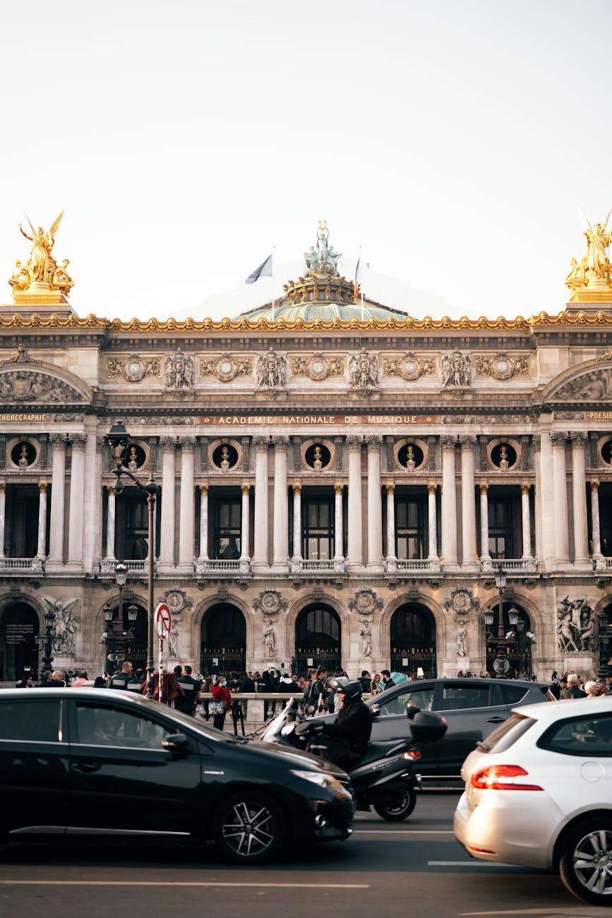 Palais Garnier at dusk with Paris street lights and activity