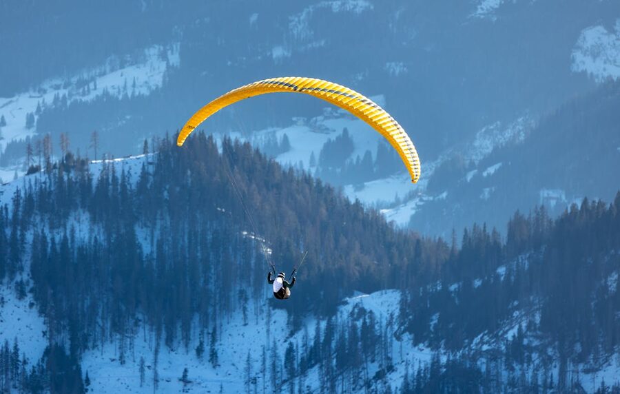 Paragliding over Alps mountains