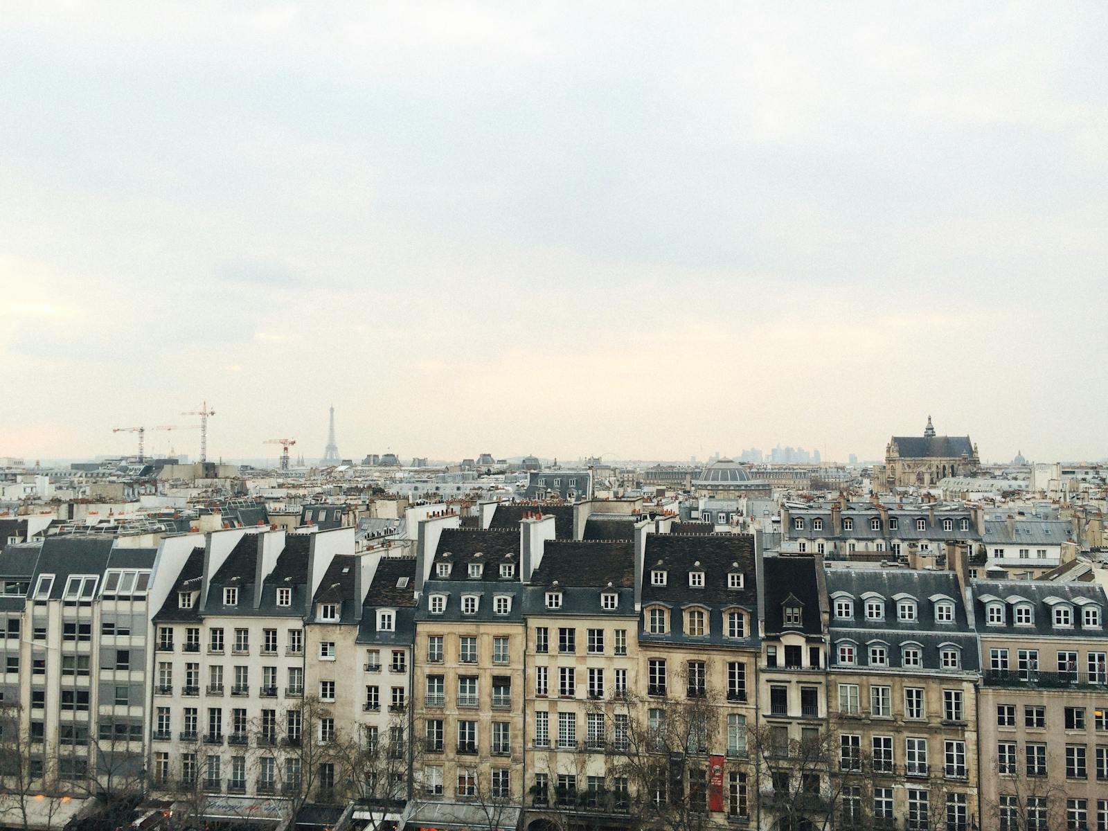 Aerial view of Paris showcasing classic architecture with Eiffel Tower in the background