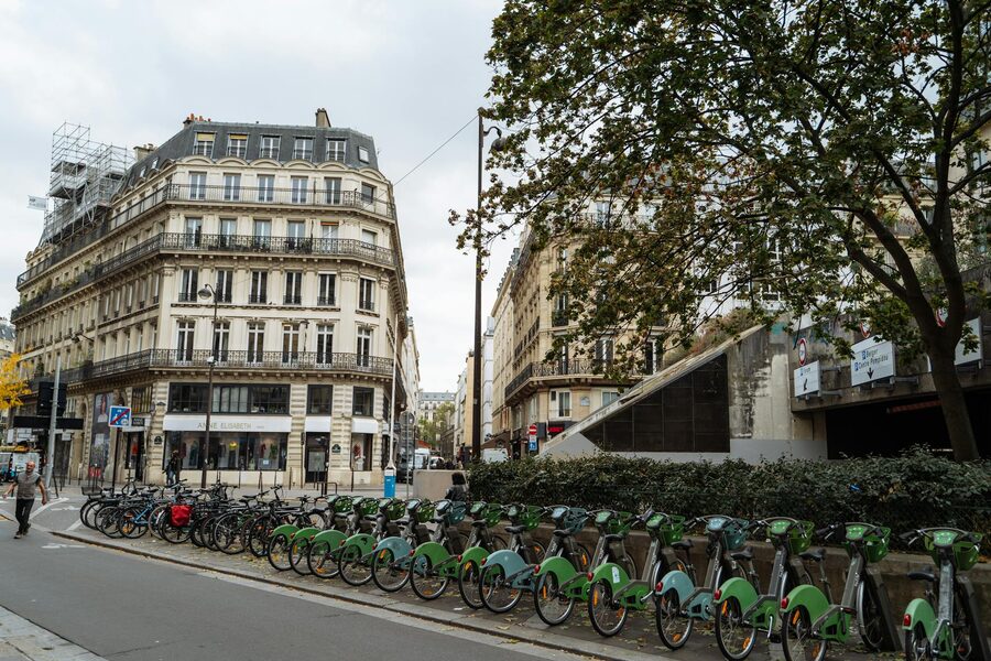 Paris street with bike share bikes and classic architecture