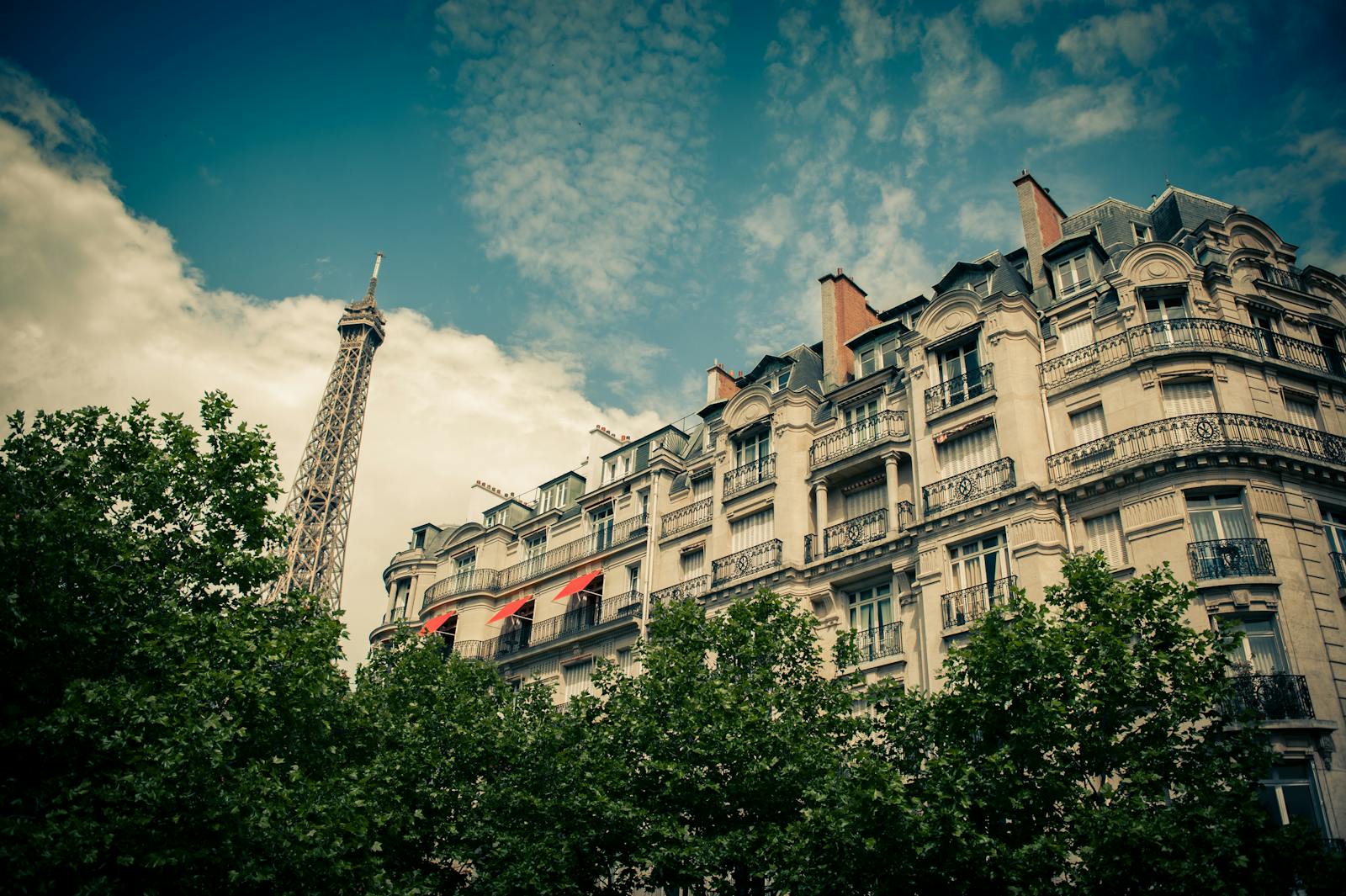 Classic Paris building with the Eiffel Tower in the background