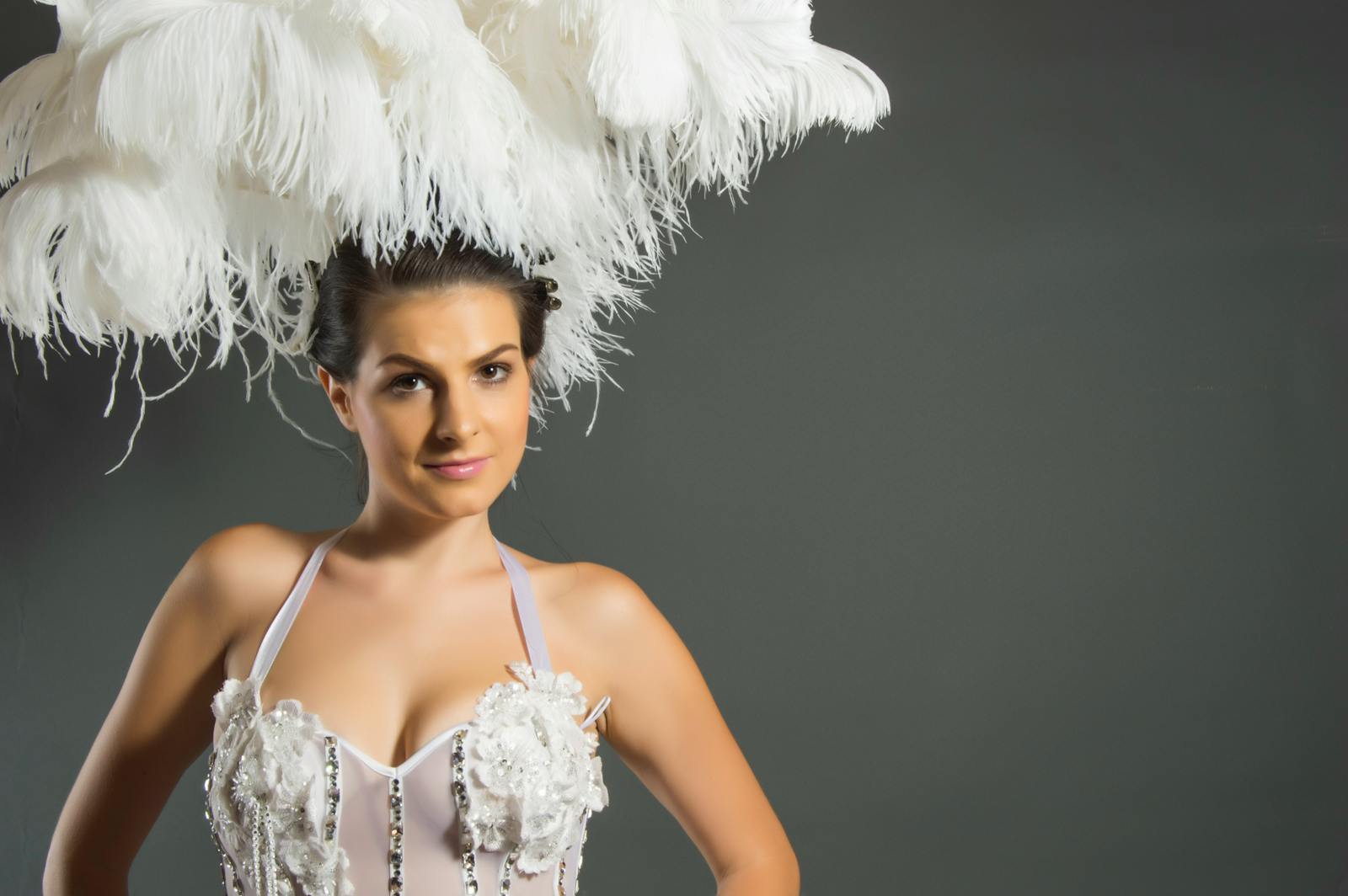 Elegant Paris cabaret performer in a feathered headpiece with classic glamour styling