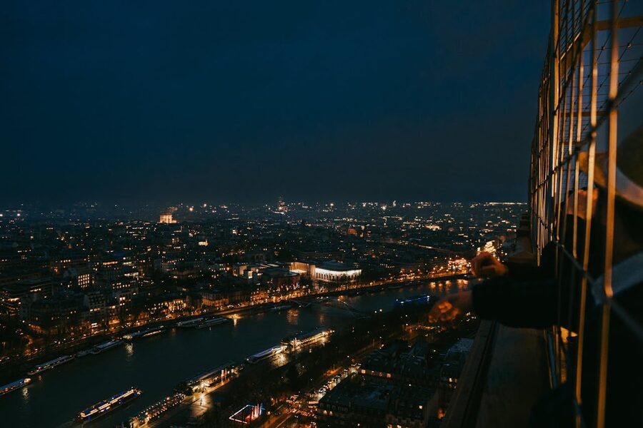 Paris cityscape seen from the Eiffel Tower at night with city lights