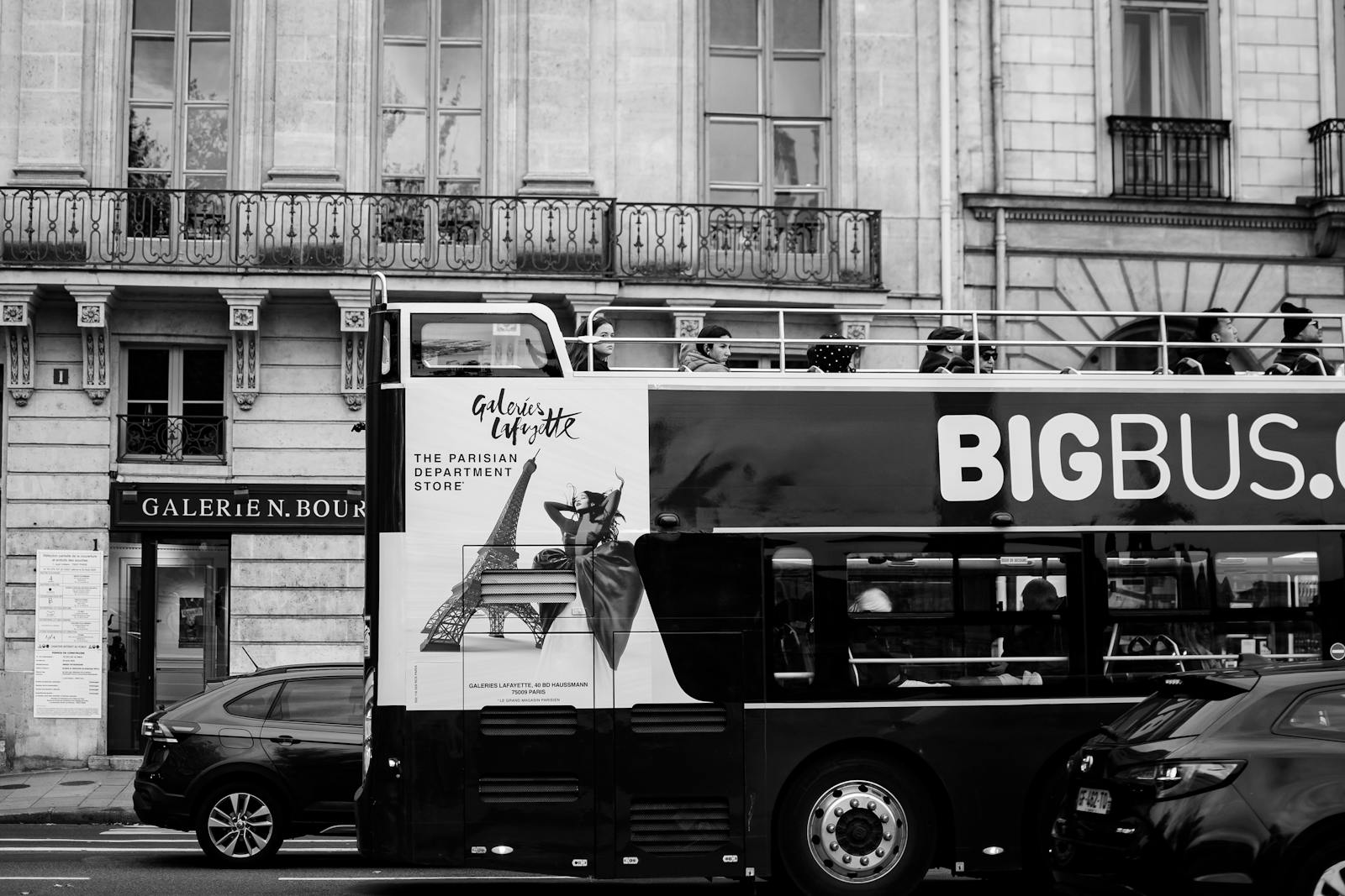 Red double-decker sightseeing bus in Paris with Galeries Lafayette signage